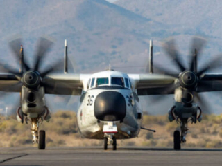 An airplane taxies towards the camera.