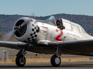 An airplane taxies past the camera