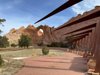 A view of a rocky cliff across a well-maintained park