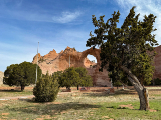 A view of a rocky cliff across a well-maintained park