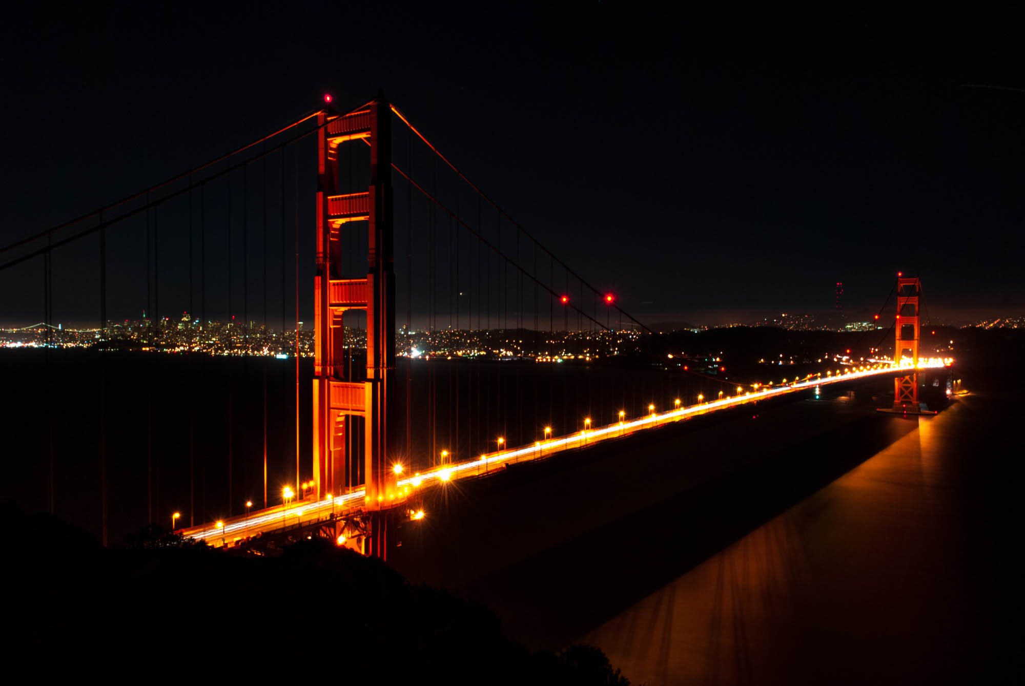 The Golden Gate Bridge at night with San Francisco in the background
