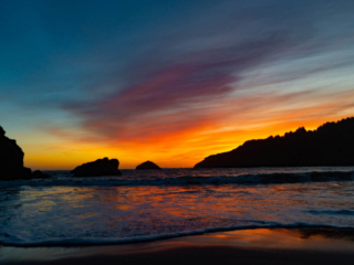 The sun sets over the ocean